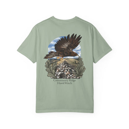 A sage green short-sleeve t-shirt with a large graphic print on the back showing an eagle flying over Commissary Ridge HawkWatch's observation